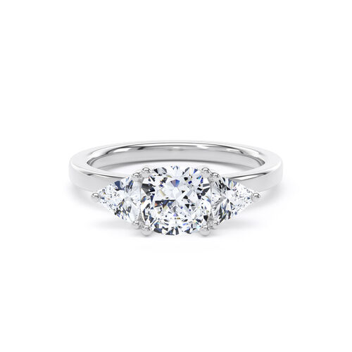 Cushion and trilliant cut diamond trilogy ring