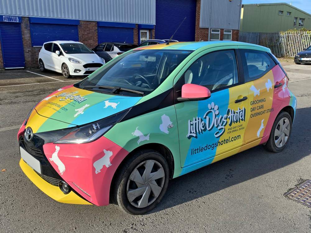 Colourful Toyota Aygo with branded vehicle wrap.