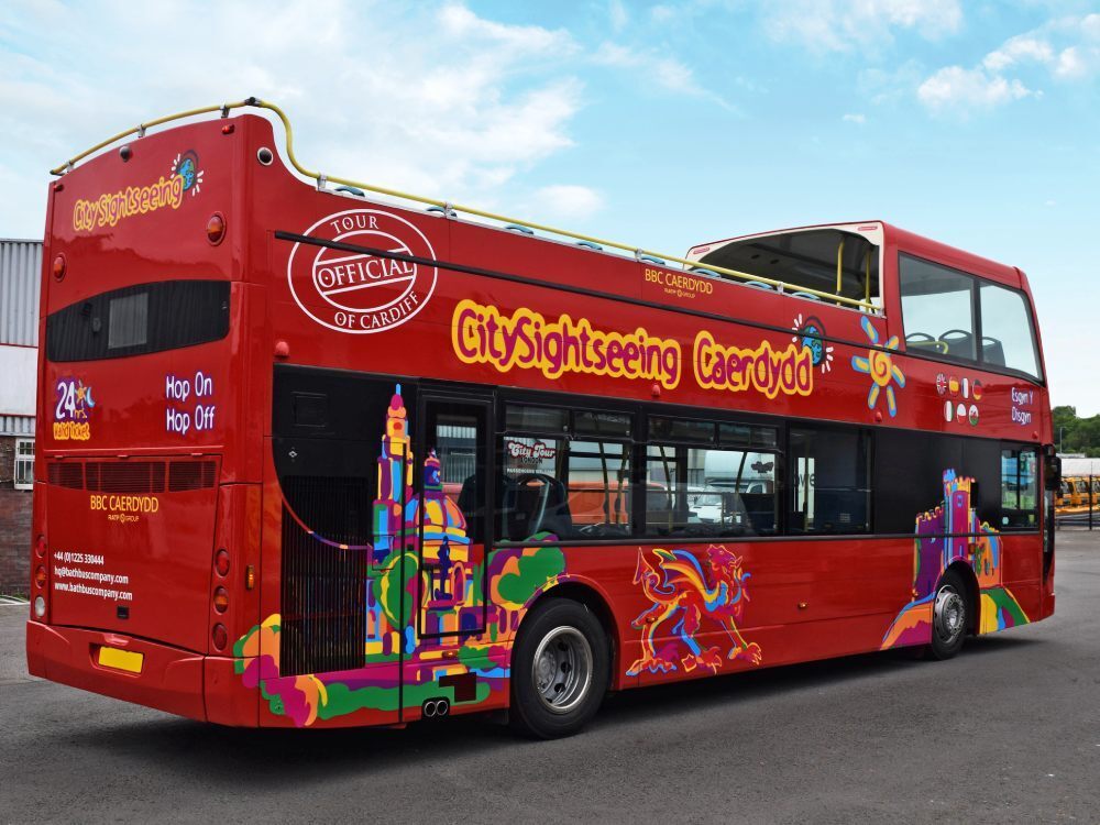 Cardiff City Sightseeing branded vinyl graphics on red Optare VLE open top tour bus.