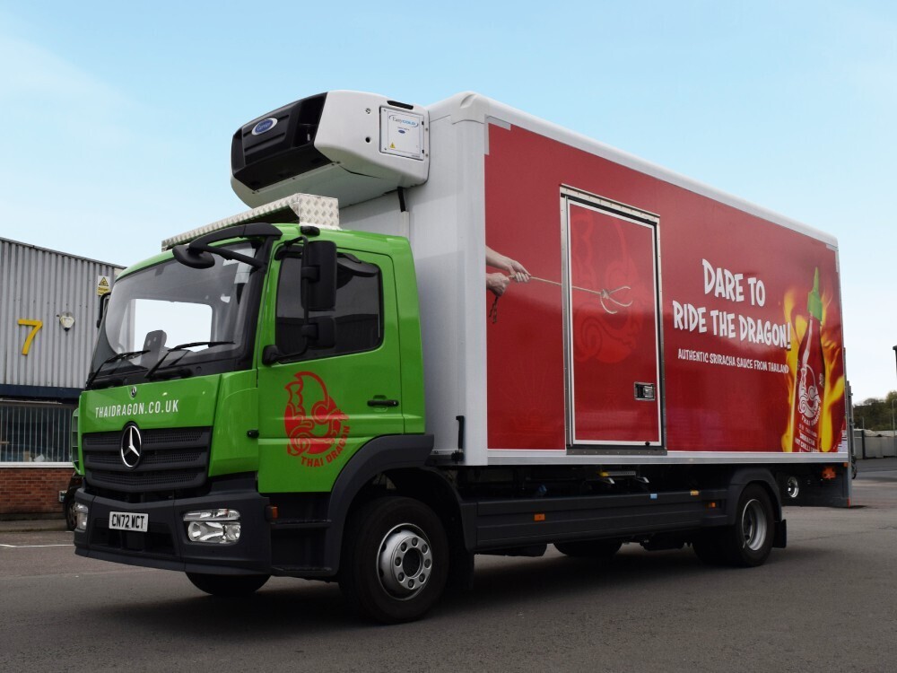 Mercedes truck with full advertising vehicle wrap and graphics.
