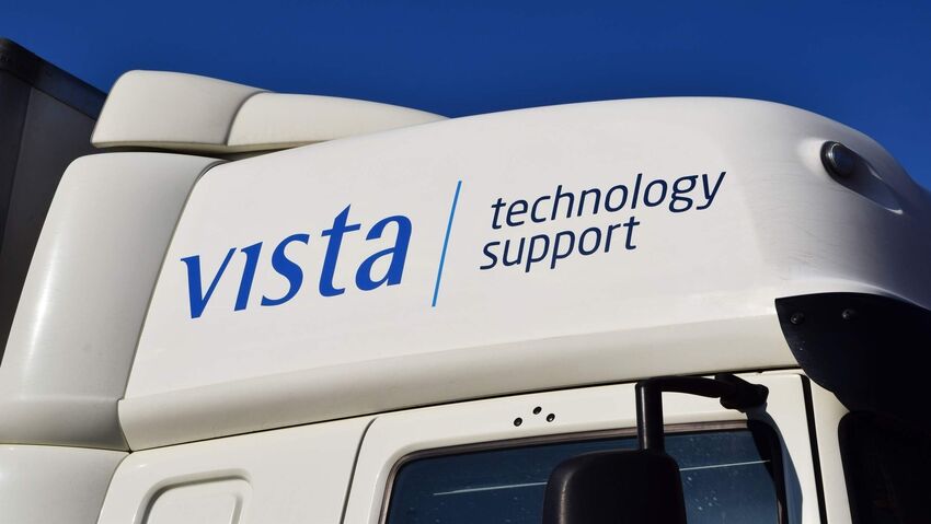 Fleet lorry cab with vinyl graphics featuring company branding.