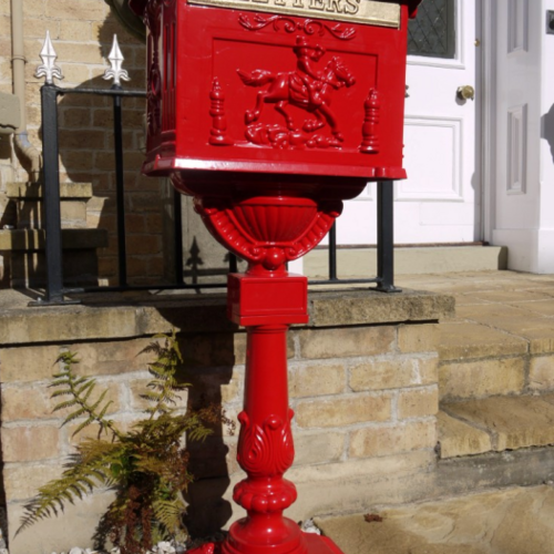 Large red metal postbox.