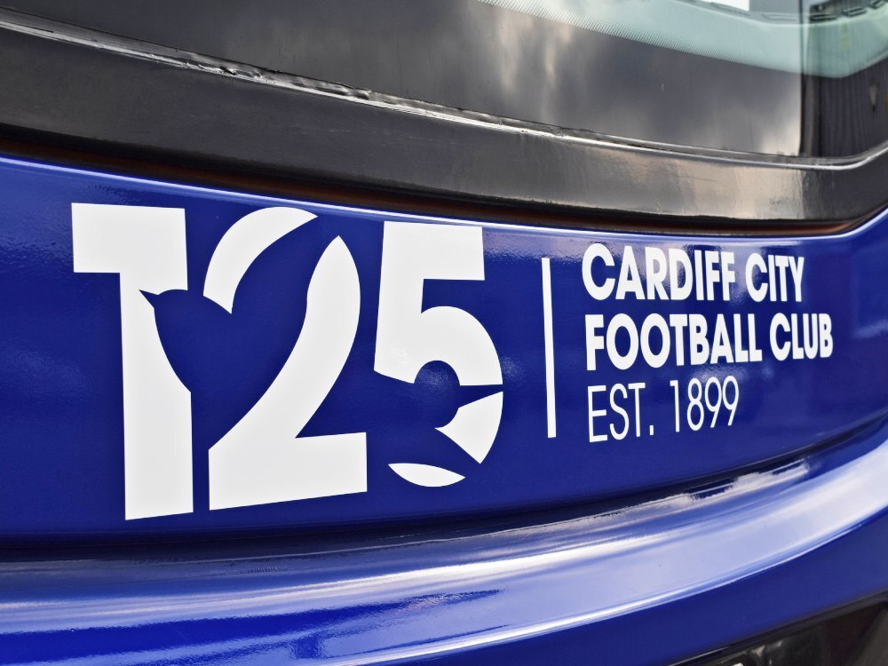 White Cardiff City FC vinyl graphics on blue Alexander Dennis Enviro 400 bus.