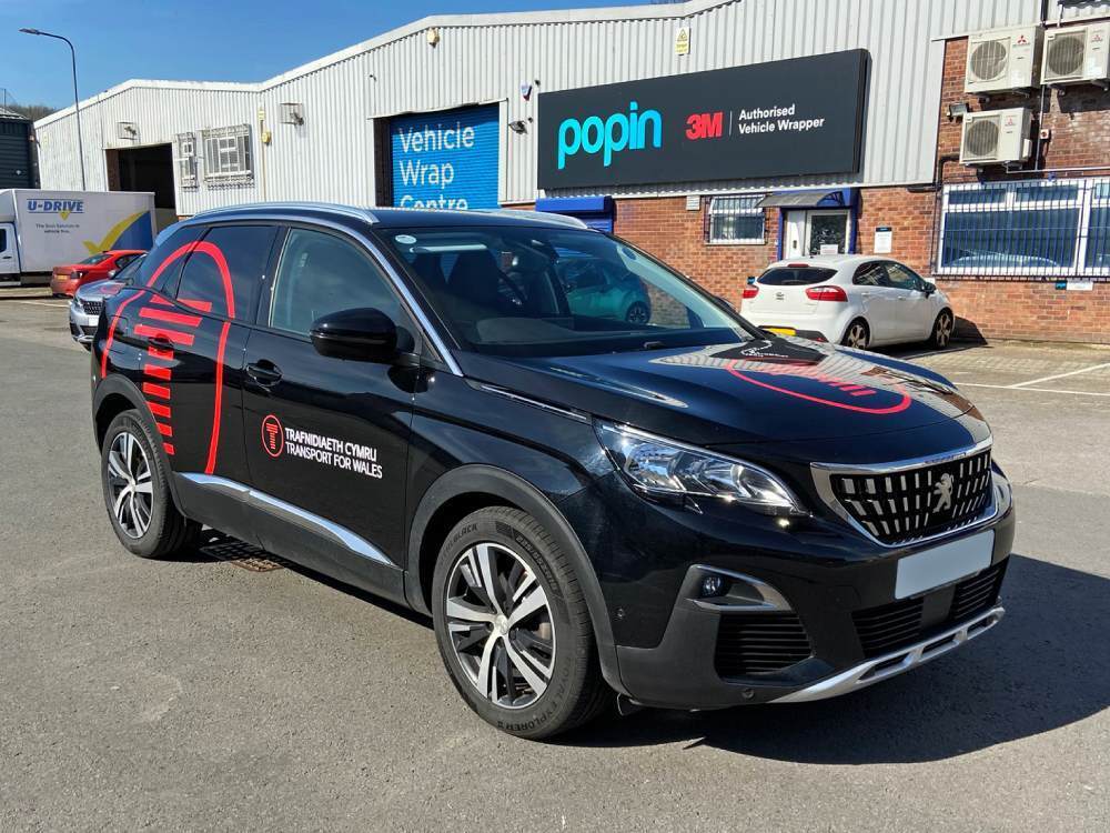 Black Peugeot 3008 company car with vinyl graphics.