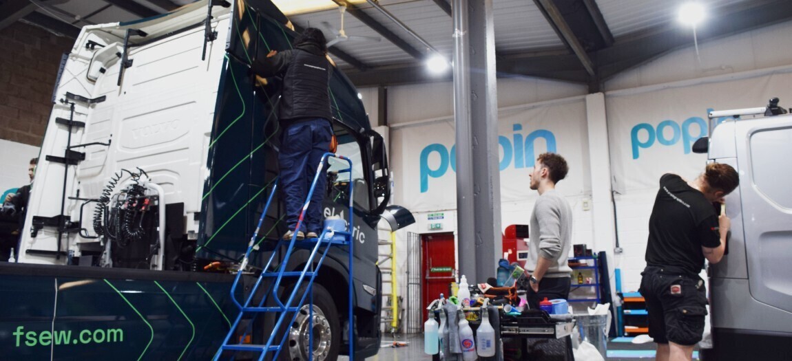 Vehicle wrap installation on a truck and van at Popin Graphics in Cardiff