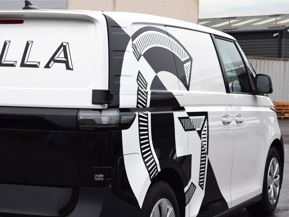 Volkswagen ID. Buzz electric company vehicle with black and white business branded vehicle wrap and graphics.