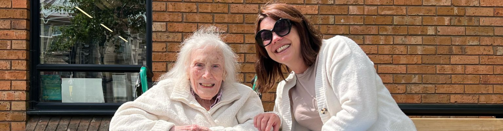 Older woman smiling with a Your Care carer outdoors, showing friendly companionship and support in Bristol.