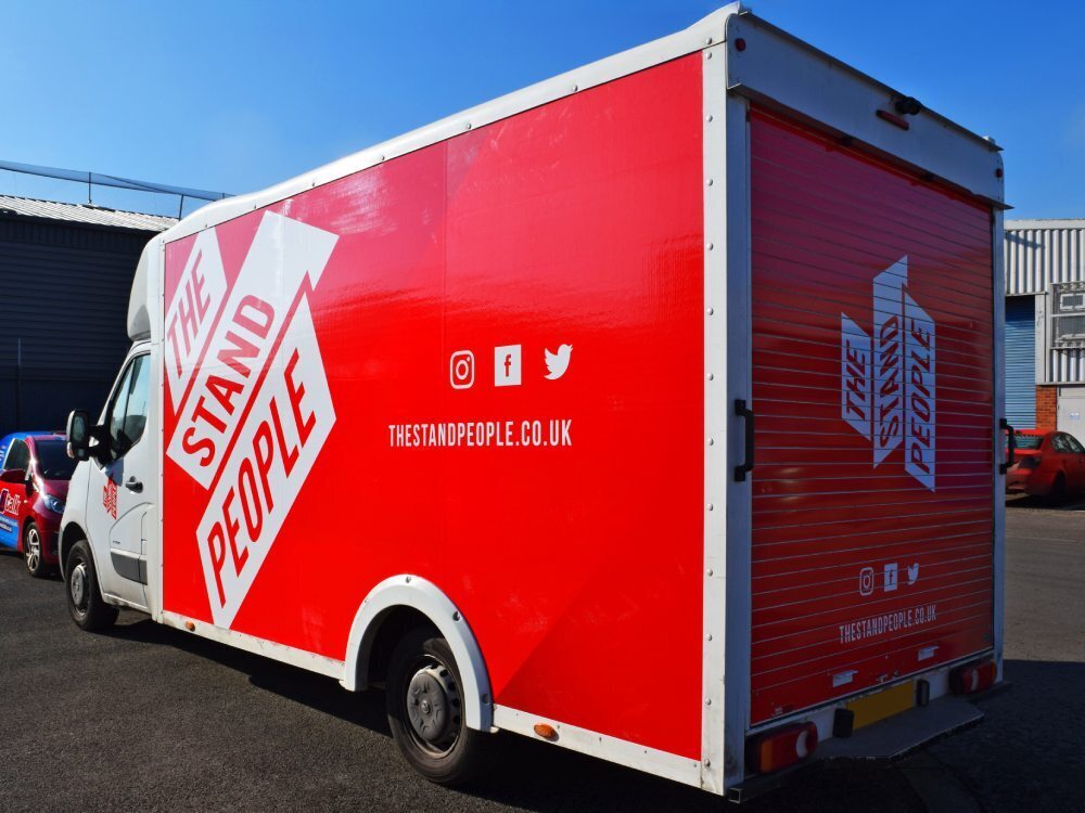 Red company branded vehicle wrap on Vauxhall Movano Box van.