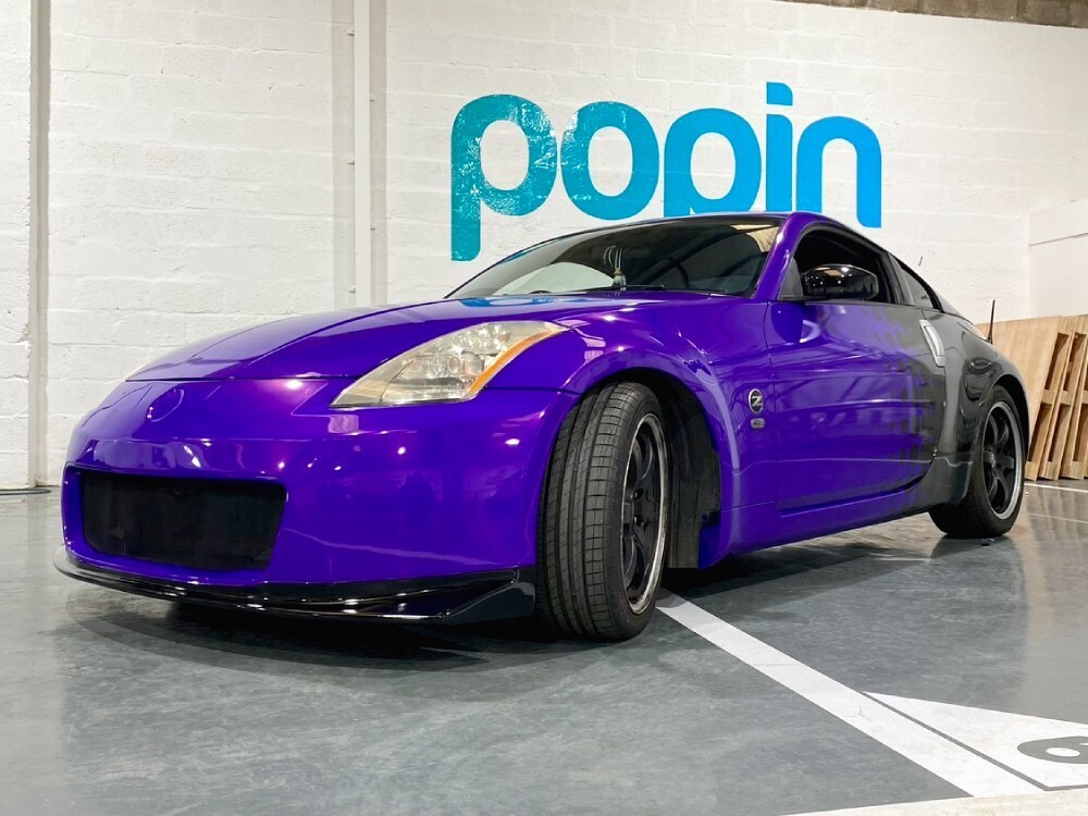 Purple motorsport wrap with black graphics on Nissan Primera sports model