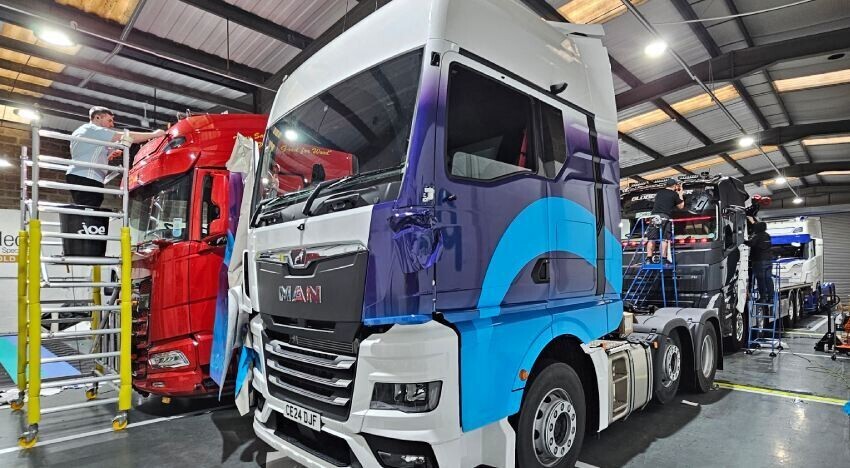 Vehicle wraps and graphics being installed onto MAN trucks at Popin in Cardiff.