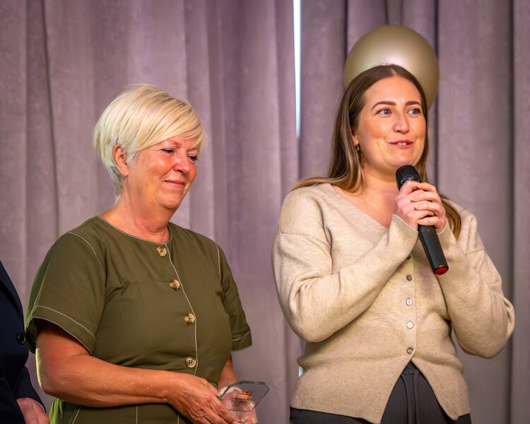 Your Care founder Tina Westlake and director Claire Westlake accepting an award on stage at the Bristol Dementia Action Alliance Awards 2026.