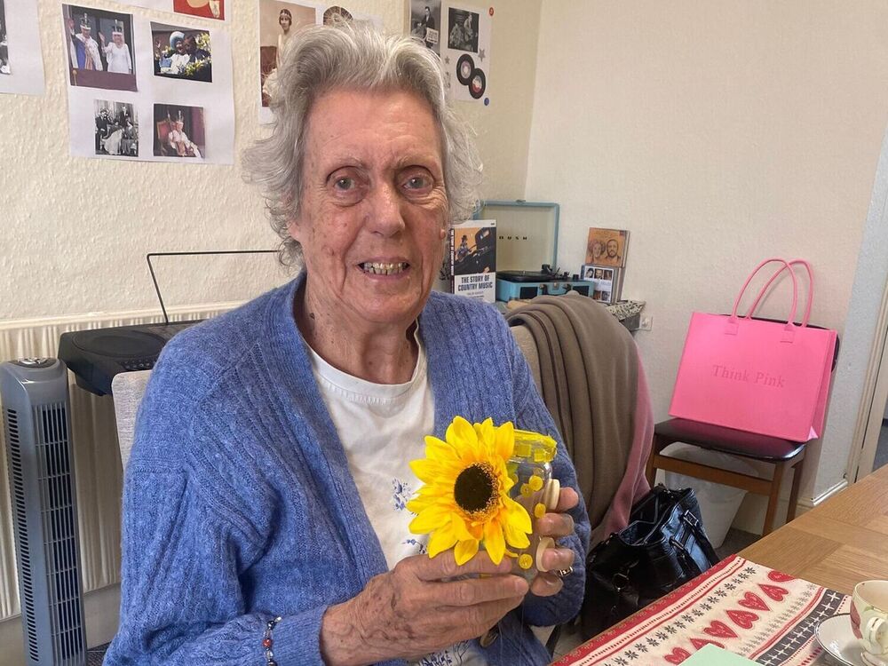 Elderly lady smiling next to her jar she decorated at her arts & crafts session at Your Care's Dementia Day Centre in Hanham, Bristol
