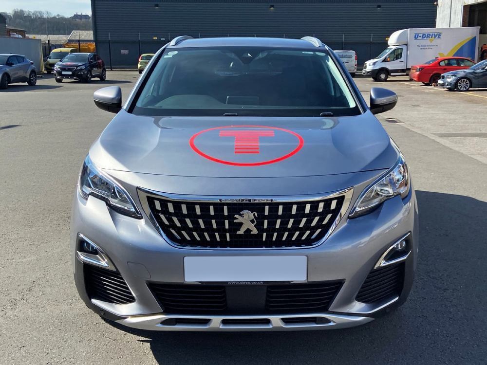 Red vinyl graphics on bonnet of silver company Peugeot 3008.