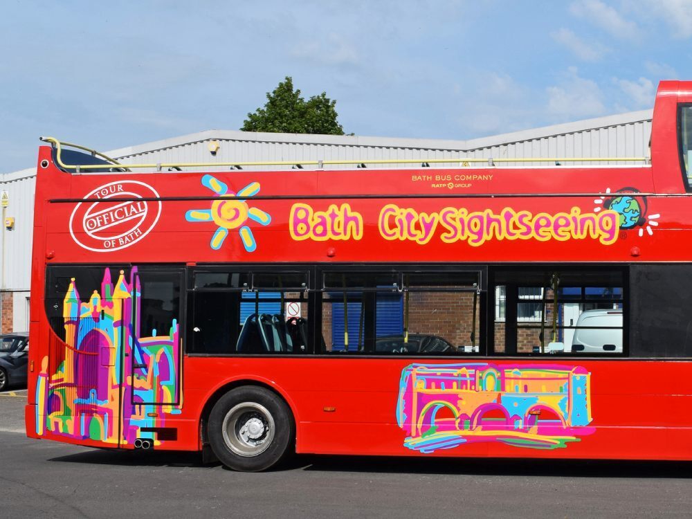 Tootbus Bath City Sightseeing red Optare VLE open top tour bus with branded vinyl graphics.
