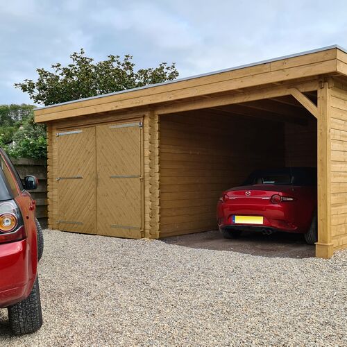 "Multi-functional timber garage with a flat roof, featuring a combination of an enclosed storage area with double doors and an open carport. The double doors showcase a traditional wood design with diagonal cross-bracing and durable metal hinges. The carport area is supported by a sturdy timber post and offers ample space for vehicle parking, as seen with a red sports car parked under the shelter. Set on a gravel driveway, this garage, supplied by Lugarde and expertly designed and installed by Forever Timber, provides both practical storage and stylish vehicle protection."
