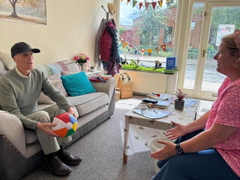 Elderly gent playing balls games with a carer at Your Care's Dementia Day Club in Bristol