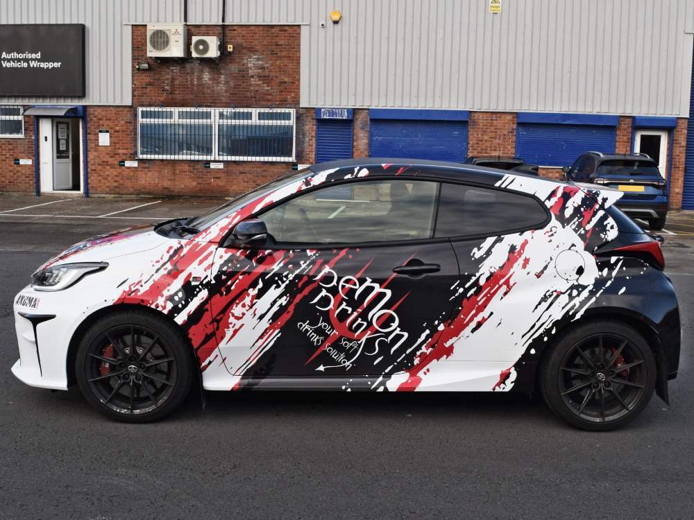 White Toyota Yaris GR with branded vehicle wrap.
