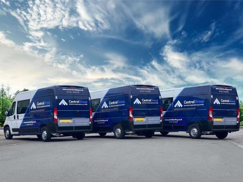 Fleet of company vans with matching vehicle wraps and graphics.