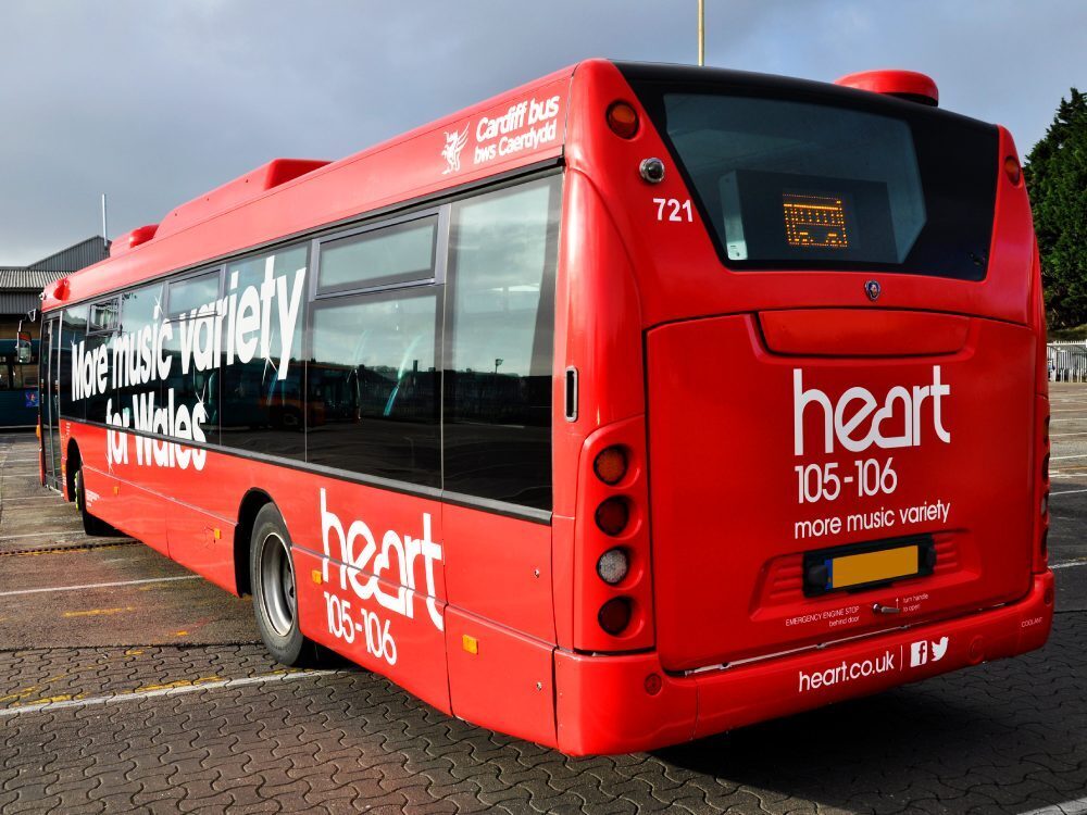 Red livery with Heart FM branded vinyl graphics on Cardiff Bus Scania Omnilink.