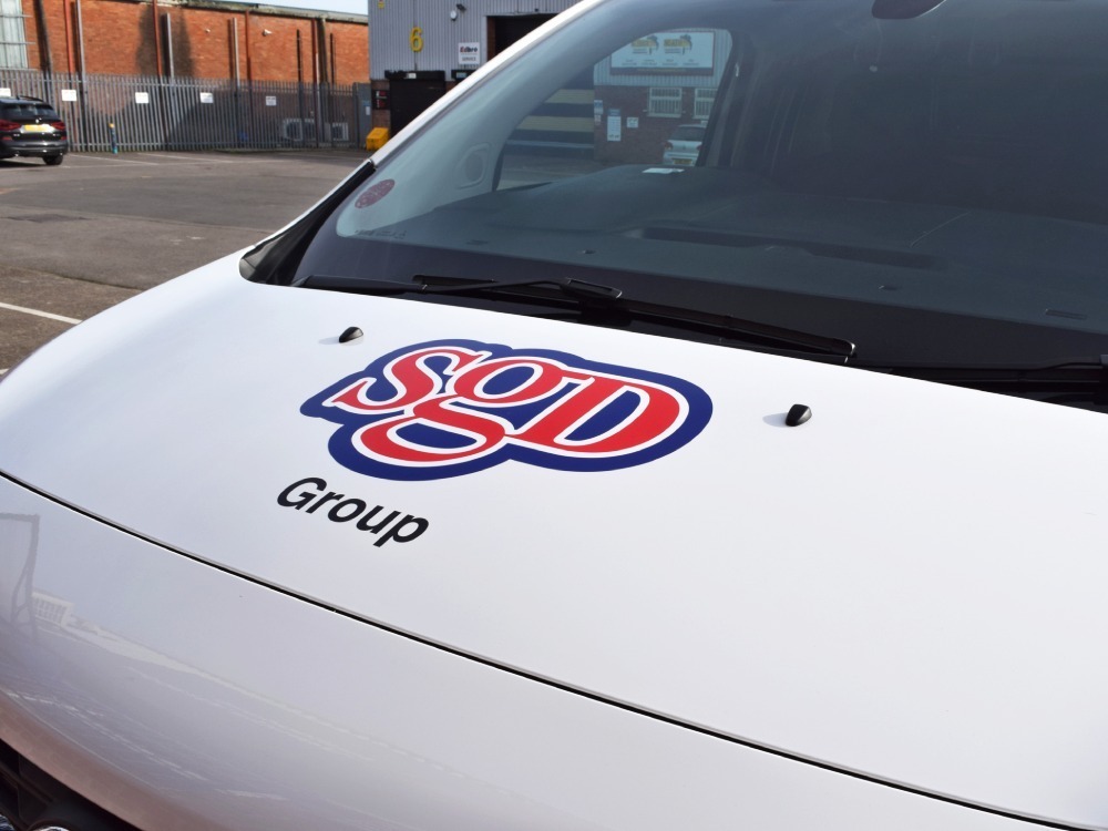 Business logo vinyl graphic on white Vauxhall Vivaro company van.