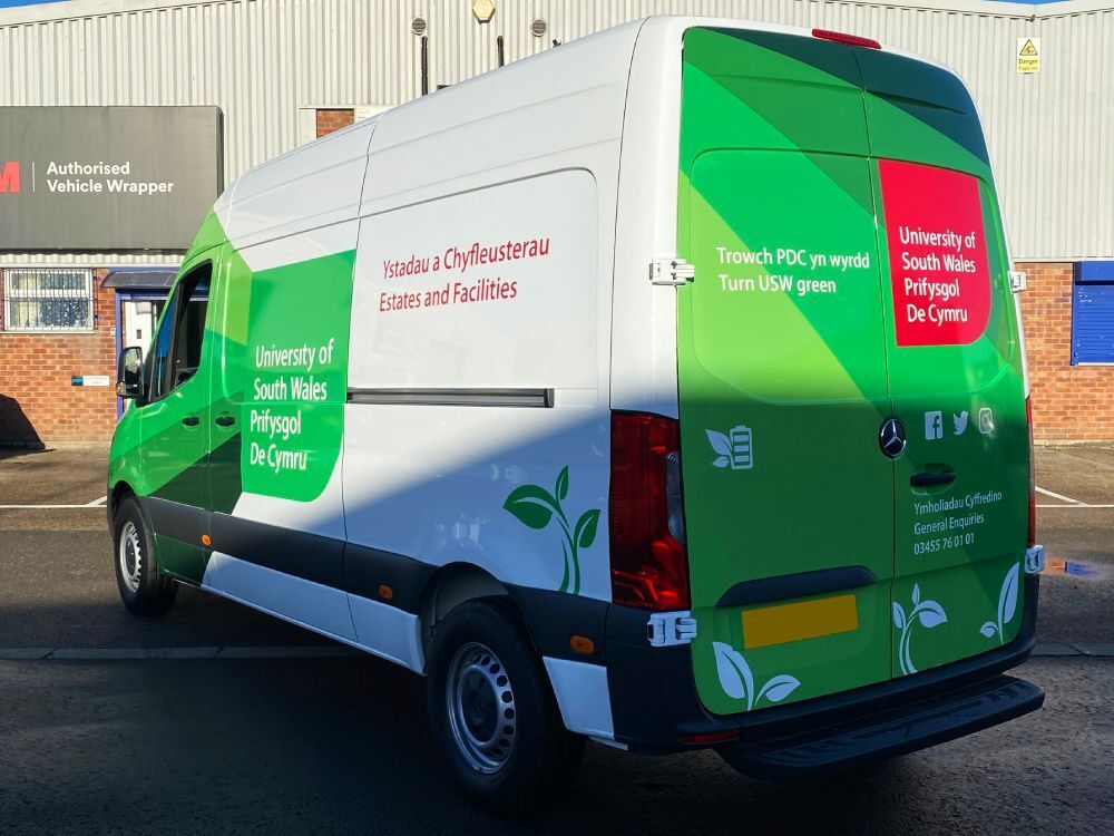 Mercedes-Benz eSprinter company van with partial wrap and University of South Wales branded graphics.
