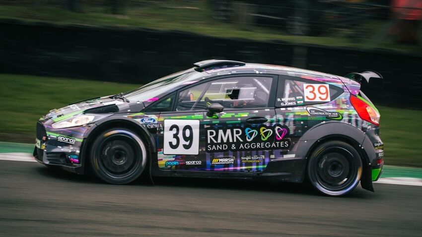 Motorsport rally car with custom vinyl wrap during race