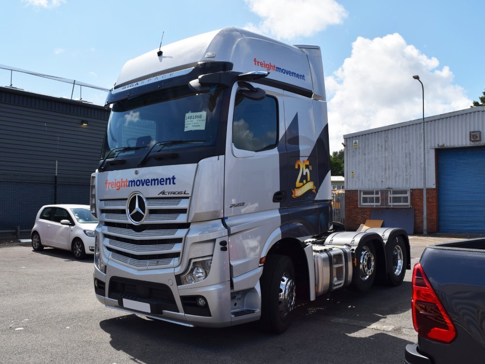 Vehicle livery and graphics on a Mercedes truck cab.