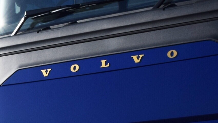 Volvo emblem on the front of a blue truck.