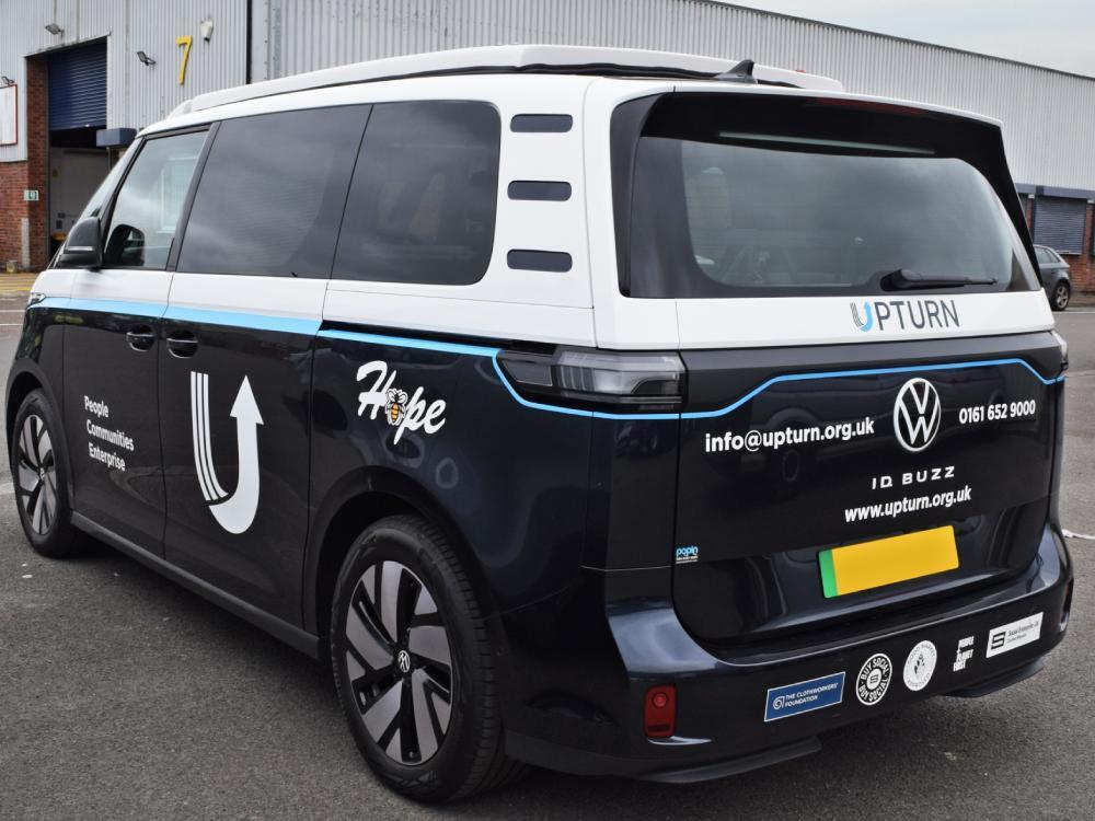 Volkswagen ID. Buzz electric company vehicle with monochrome livery and business branded graphics.