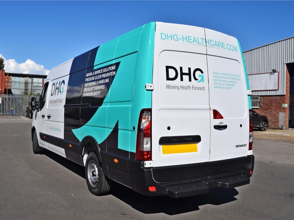 Branded partial vehicle livery and vinyl graphics on white company Renault Master van.