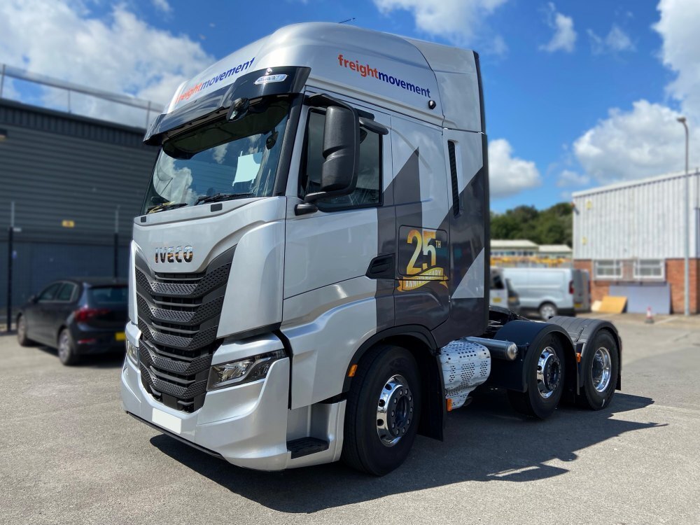 Iveco company lorry cab with branded vehicle wrap and graphics.