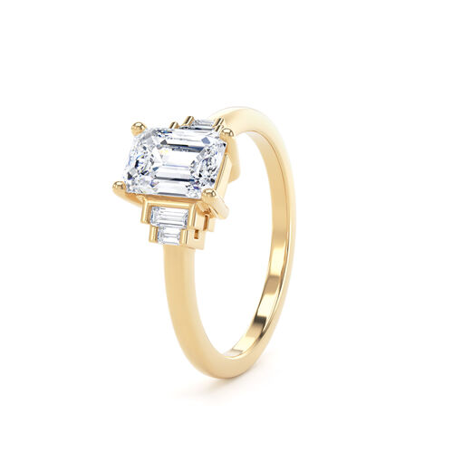 Emerald cut solitaire with stepped baguette cut diamond shoulders