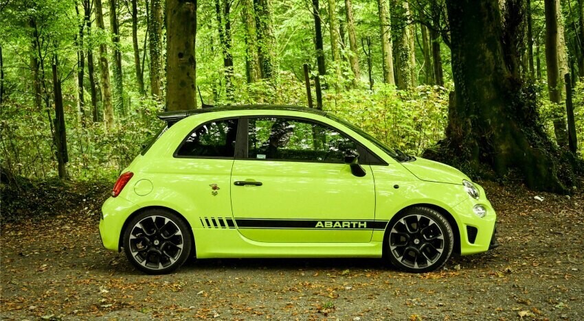 Motorsport livery and graphics on a yellow Abarth 595 Competizione sports car