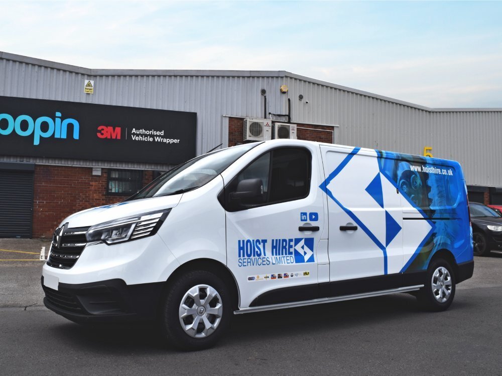 Partial branded van wrap on white company Renault Trafic van.
