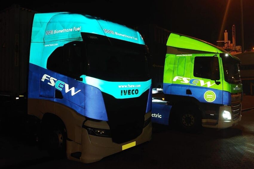 Branded reflective vinyl wraps applied to two Iveco HGV trucks for night visibility.