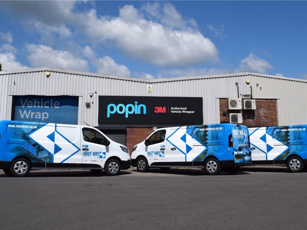 Fleet of branded company vans with newly installed vehicle wraps and graphics outside Popin in Cardiff.