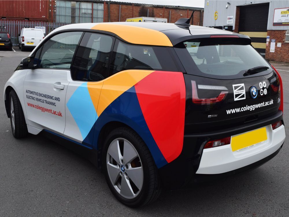 BMW i3 electric company car with rear partial livery and branded vinyl graphics.