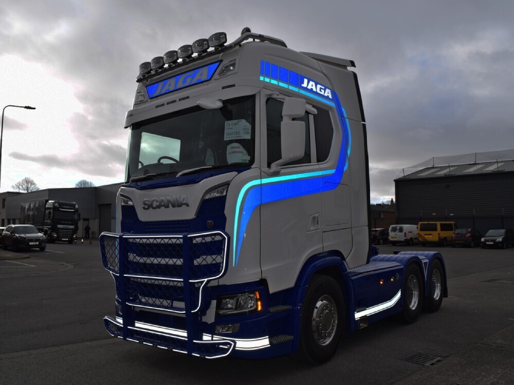 Highly reflective vinyl graphics displayed on a Scania truck.