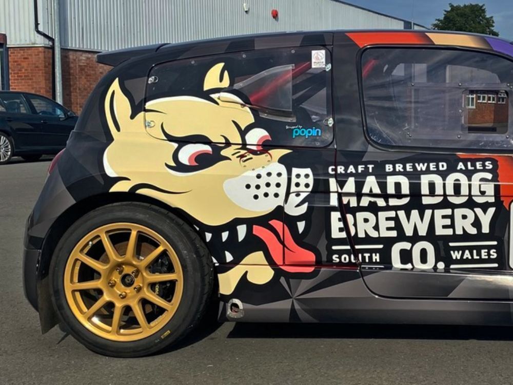 Back end of Renault Clio V6 with branded vehicle livery.