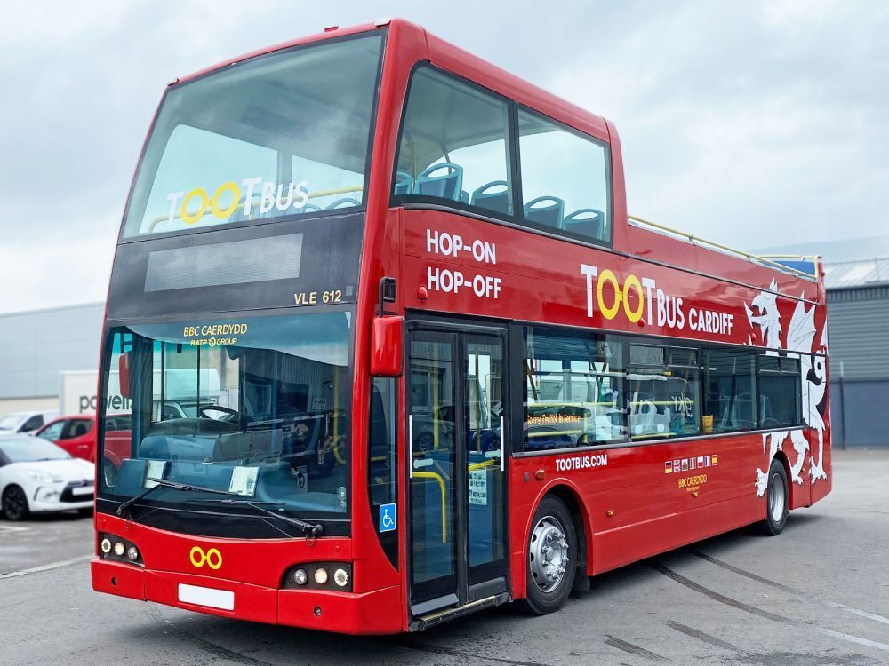 Red Tootbus company branded Ayats Bravo city open top tour bus with vehicle graphics.