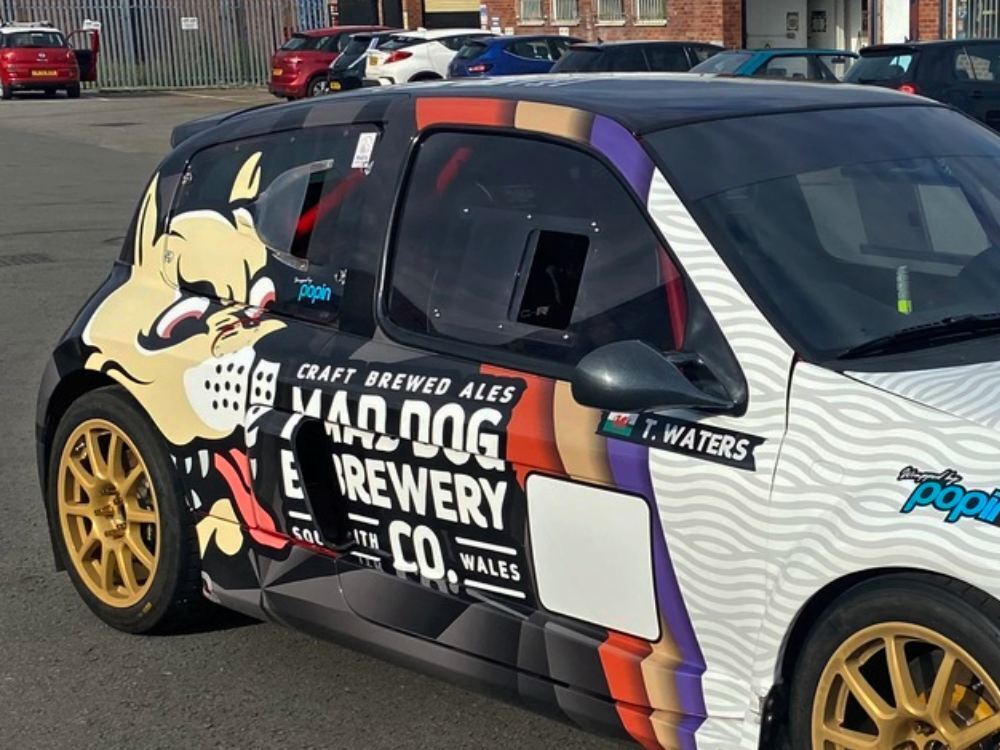 Branded vehicle wrap on rear of company Renault Clio V6.