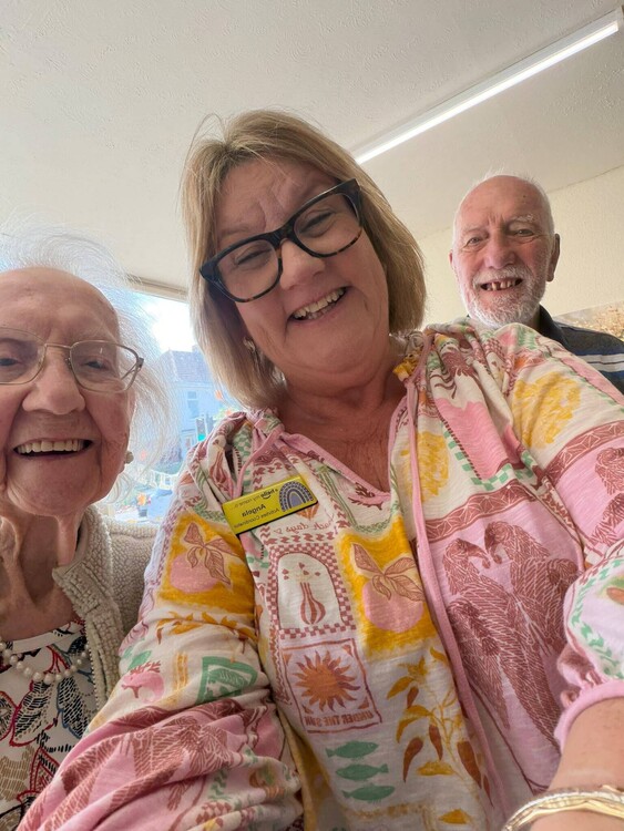 Activity Coordinator Angela smiles for a selfie with two guests at Your Care Dementia Day Club in Hanham.