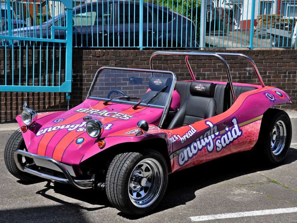 Pink promotional vehicle wrap on Braces Bread Volkswagen Meyers Manx company car.