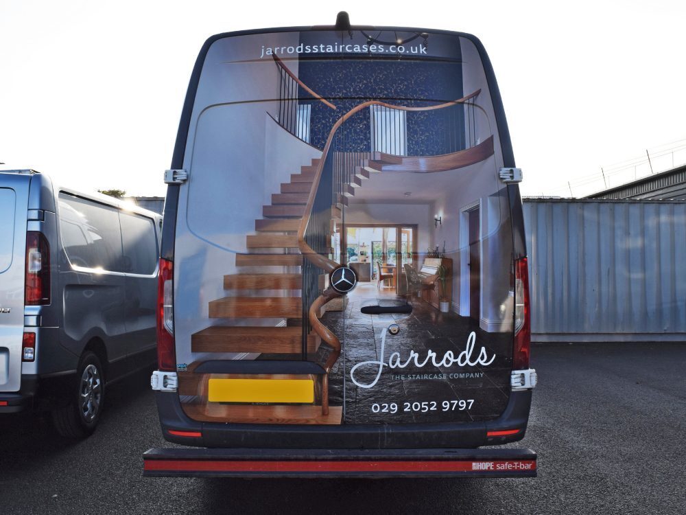 Vehicle wrap on rear of Jarrods Mercedes Sprinter company van.
