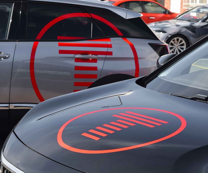 Vinyl graphics for vehicle business branding on a window and bonnet of two Peugeot 3008 cars
