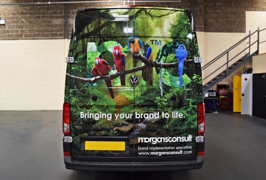 Colourful vehicle wrap of a wildlife image on the rear of a business' company van.