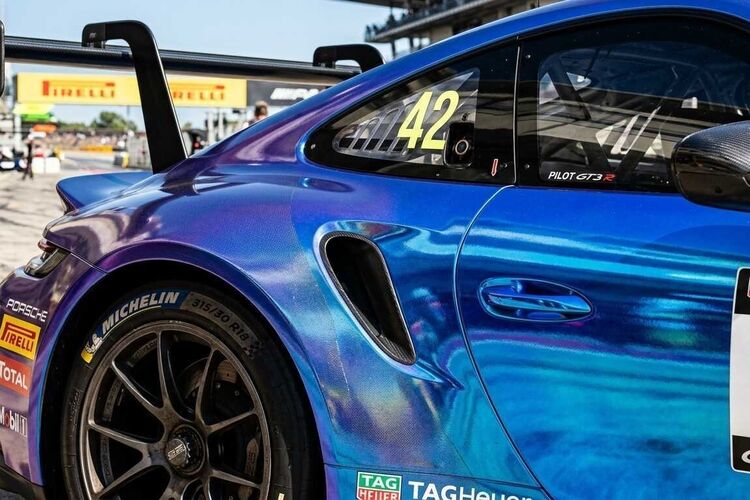 Blue metallic vinyl wrap film on a Porsche race car.