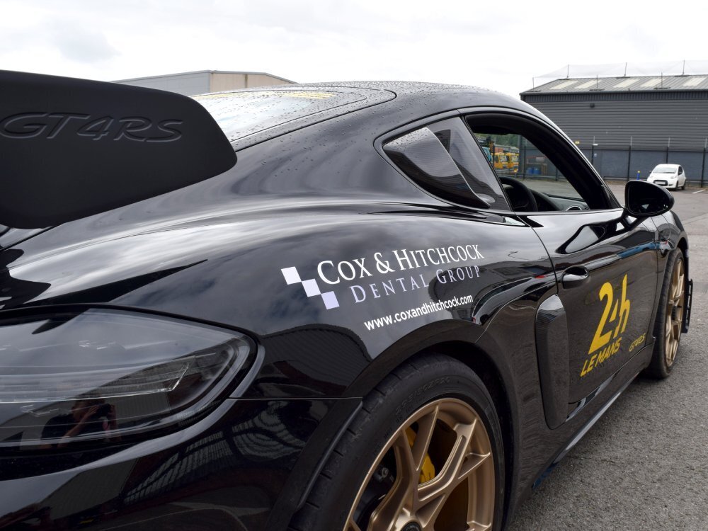 Race car graphics on a black Porsche GT4 RS