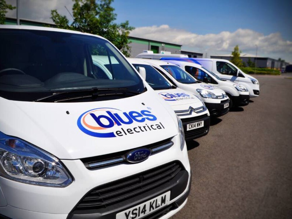 Branded vehicle vinyl graphics on front end of company fleet of vans.