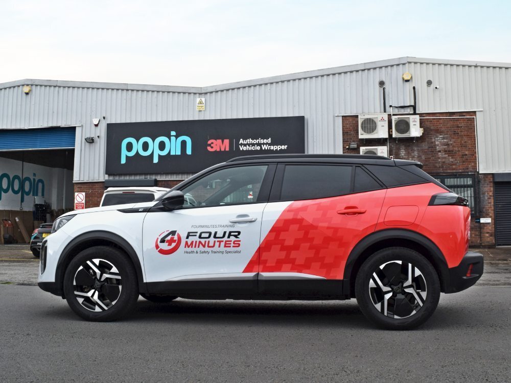 Peugeot 2008 company car with branded partial wrap.